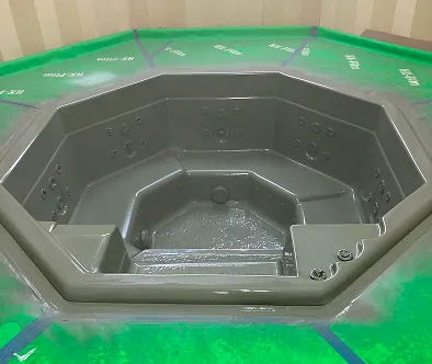 Octagonal hot tub with built-in seats and jets