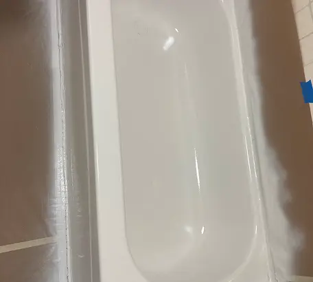 Close-up of professionally refinished white bathtub with smooth glossy finish in Brooklyn