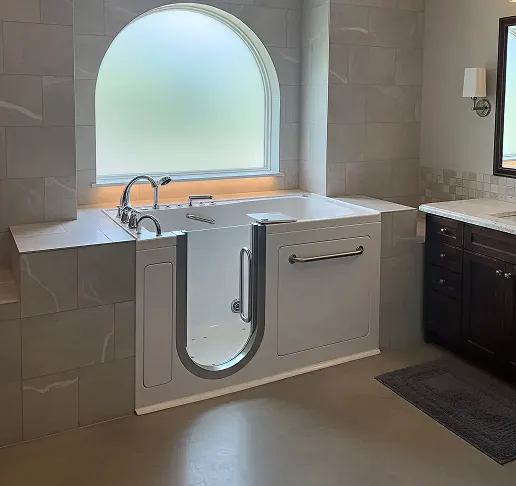 Walk-in bathtub with chrome fixtures and a curved window above.